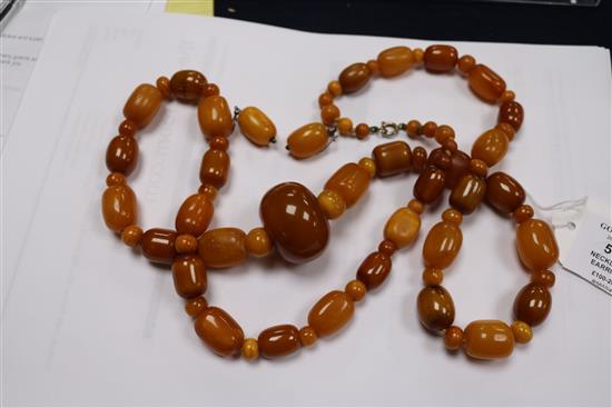 A part amber bead necklace and a pair of amber bead earrings.